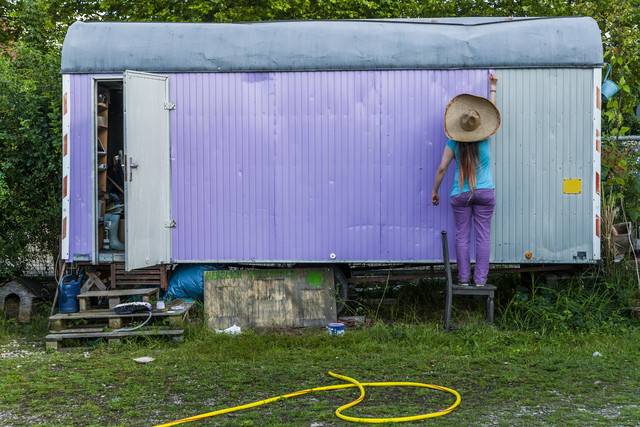 Woman painting trailer in garden
Royalty free image