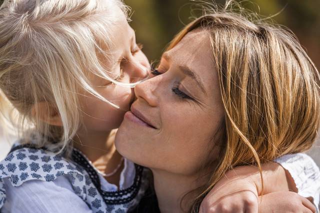 Girl hugging and kissing smiling mother
Royalty free image