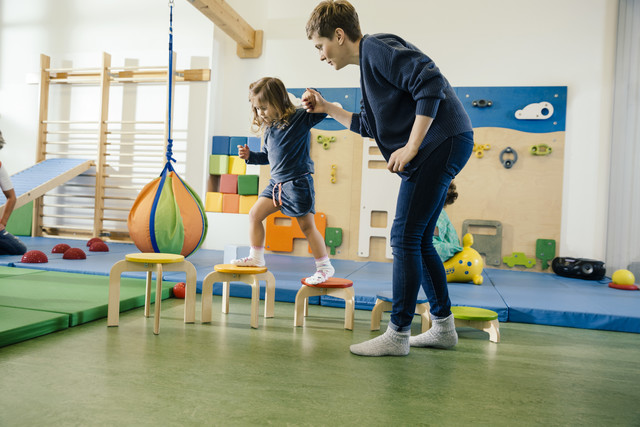 Pre-school teacher helping little girl walking on steps Royalty free image Pre-school teacher helping little girl walking on steps
Royalty free image