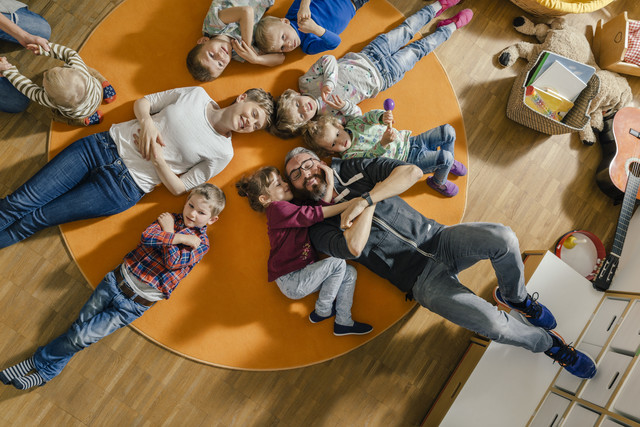 Children and teachers lying on carpet in kindergarten Royalty free image Children and teachers lying on carpet in kindergarten
Royalty free image