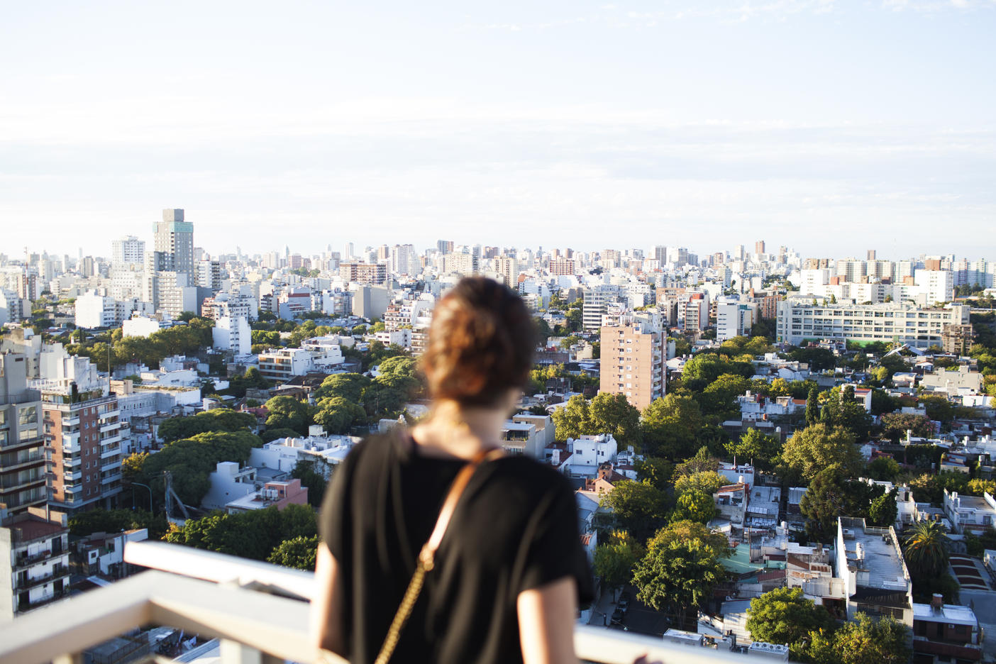 Rear view of woman standing at building terrace against cityscape
Royalty free image