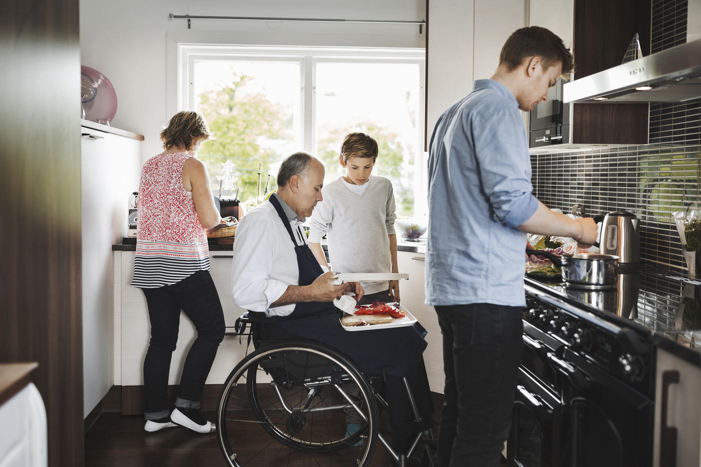 Parents and children preparing food together in kitchen Royalty free image Parents and children preparing food together in kitchen
Royalty free image