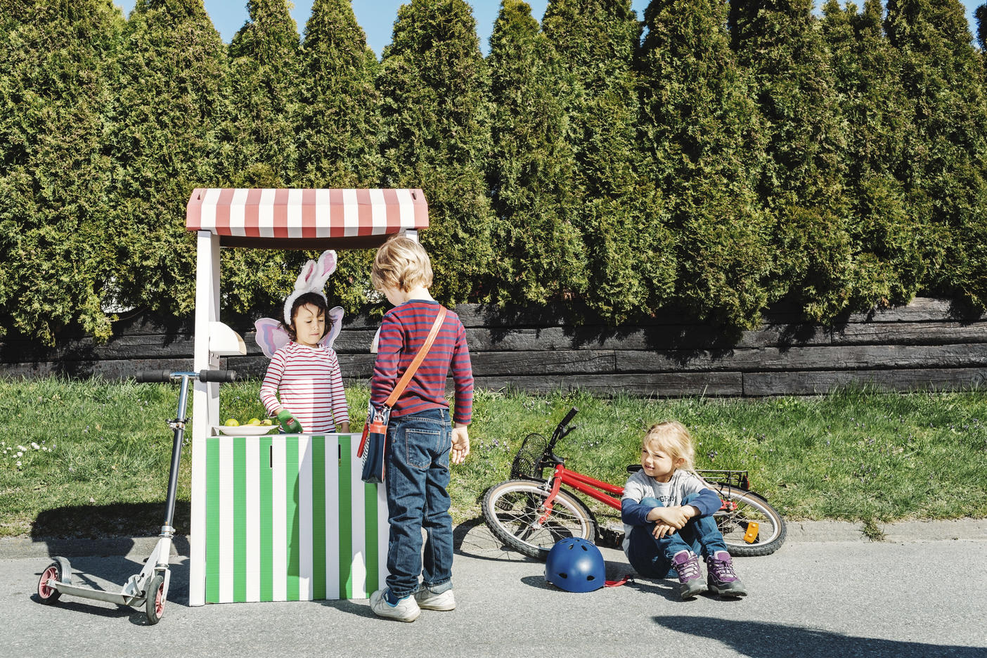 Boy standing at food stall while friend imitating as seller on footpath Royalty free image Boy standing at food stall while friend imitating as seller on footpath
Royalty free image