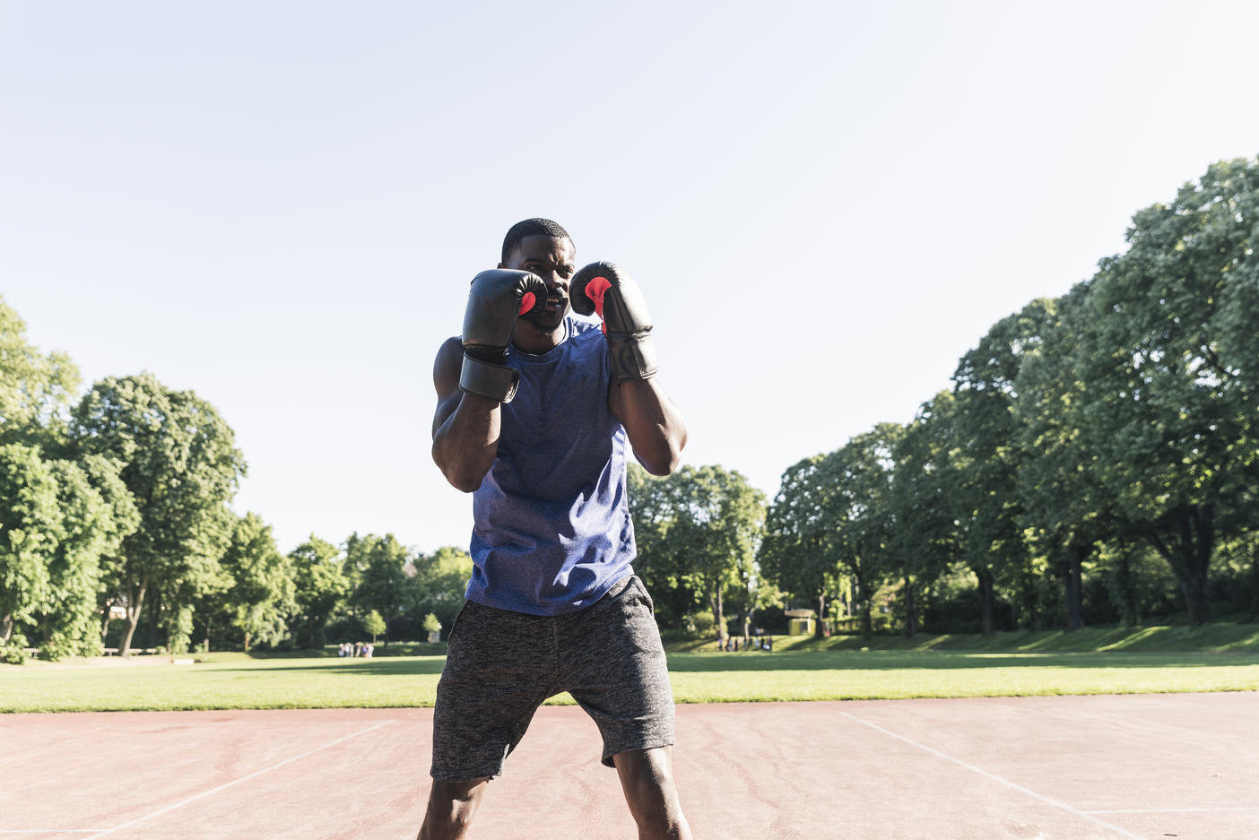 Young Afro-American man training boxing on sports field, outdoors
Royalty free image
