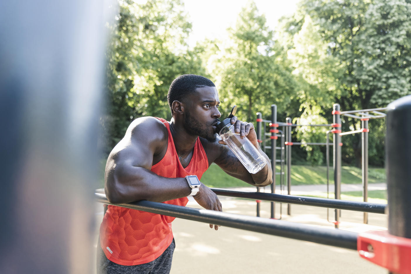 Young athlete training on parallel bars, outdoors, drinking water
Royalty free image
