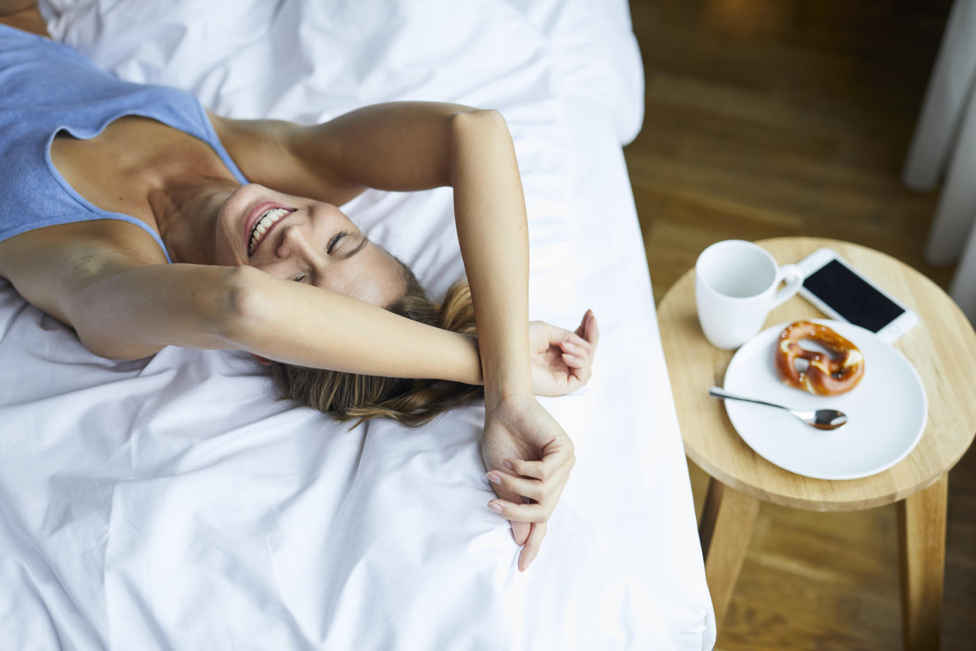 Laughing young woman lying in bed
Royalty free image