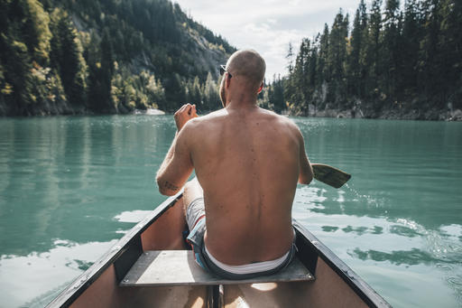 Canada, British Columbia, barechested man in canoe on Kinbasket Lake
Royalty free image