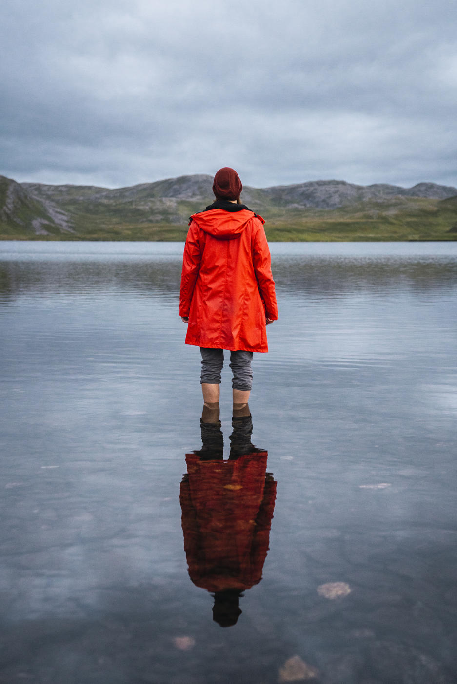 Young man standing ankle deep in water, looking at distance, rear view Royalty free image Young man standing ankle deep in water, looking at distance, rear viewRoyalty free image