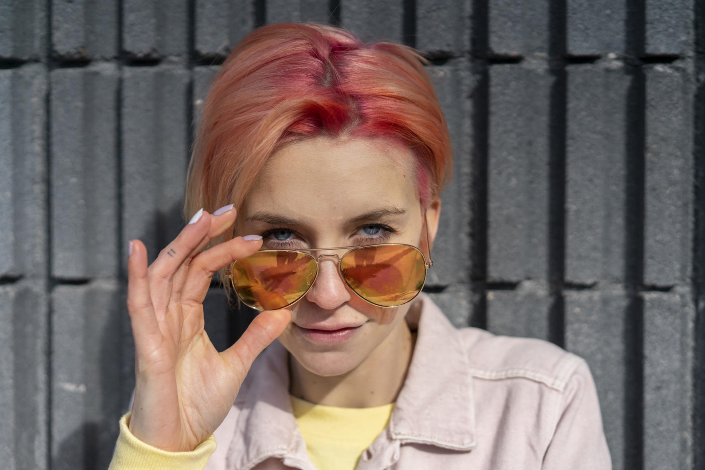 Portrait of young woman, sun glasses and pink jeans jacket
Royalty free image