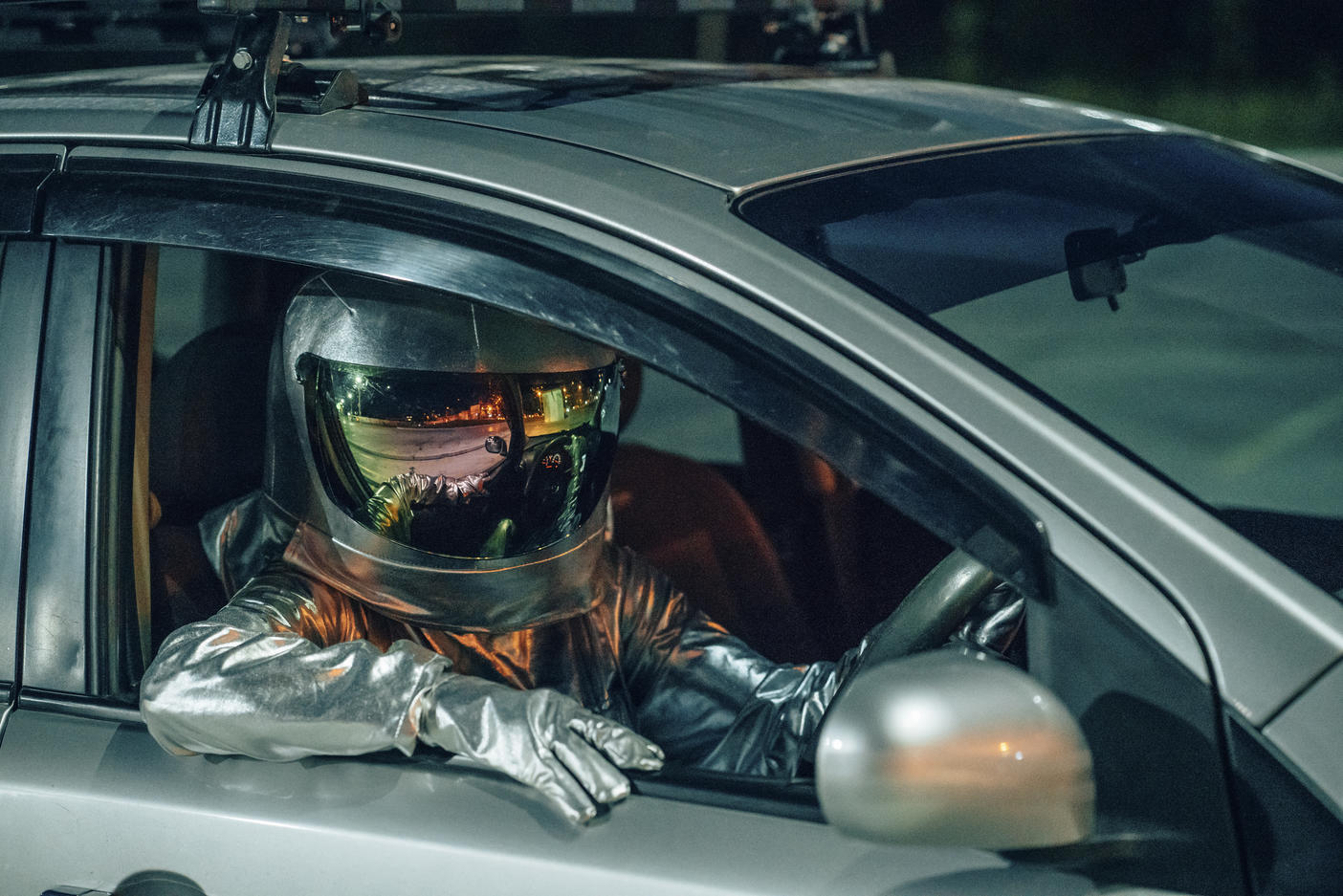 Spaceman sitting in car at night
Royalty free image