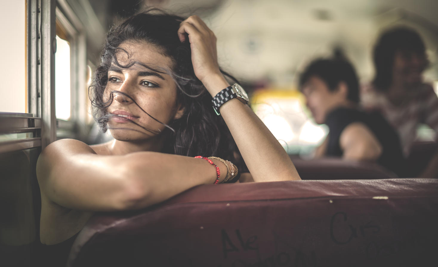 A young woman sitting on a school bus looking out of window.
Royalty free image