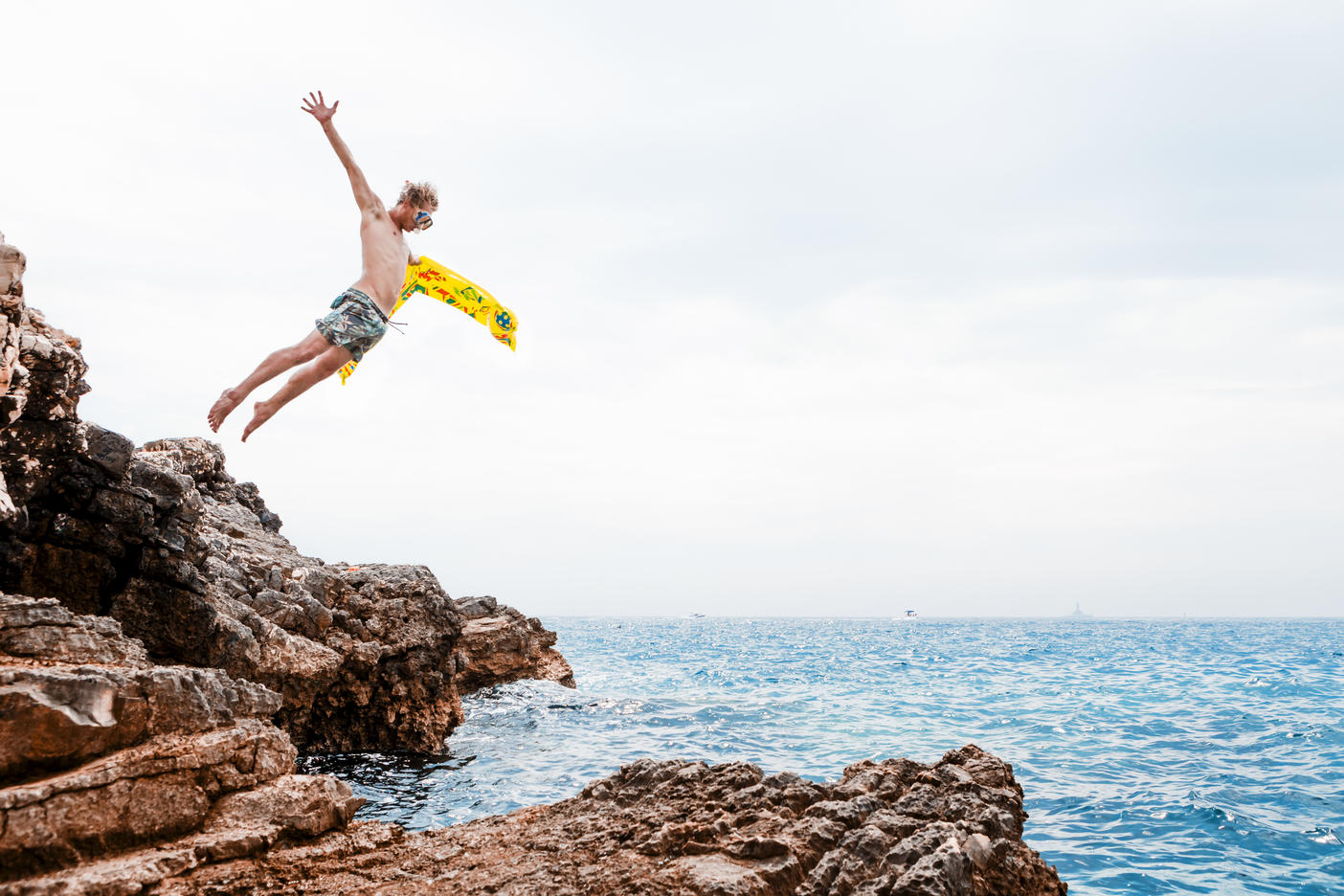 Man with airbed jumping from rock into the sea
Royalty free image