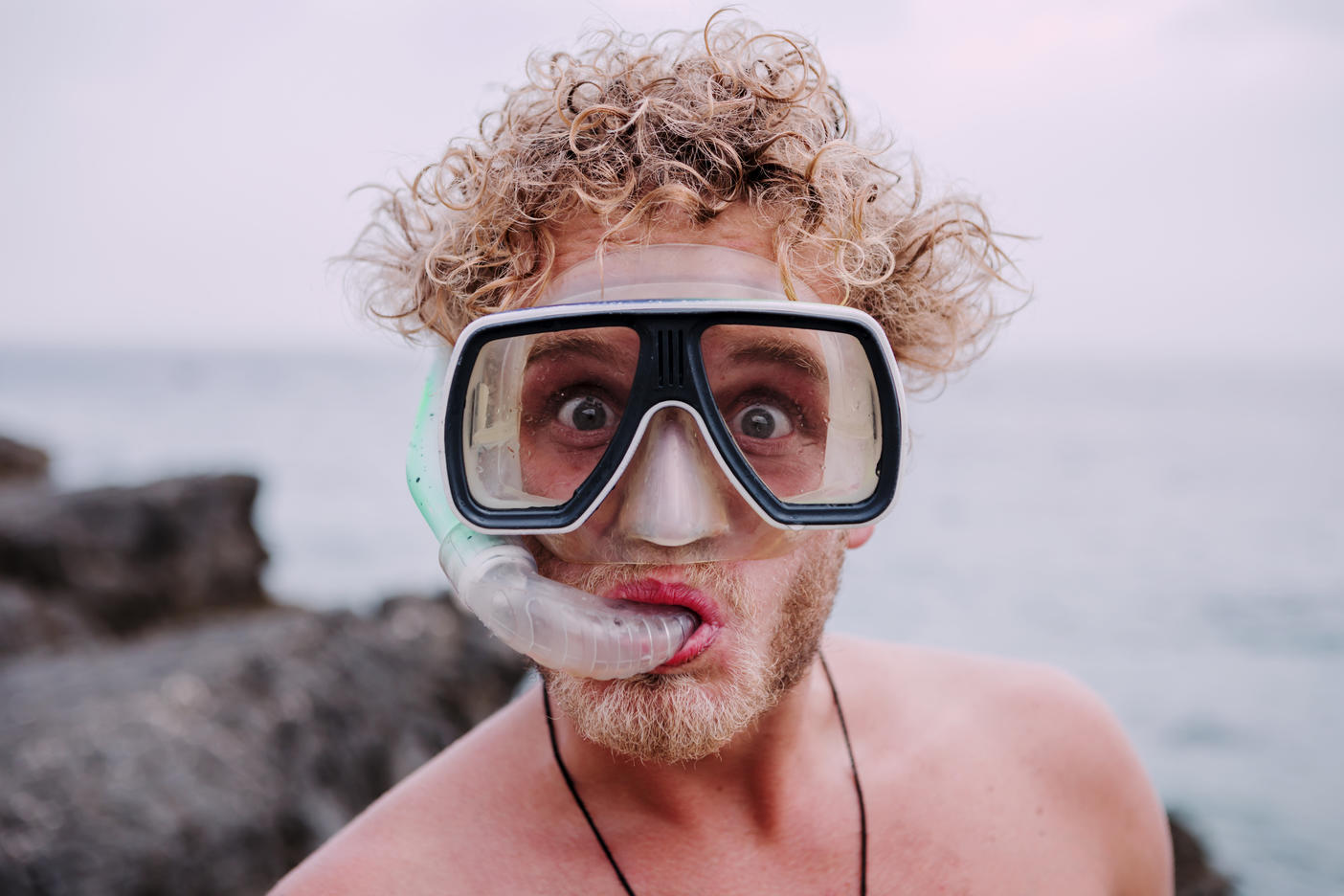 Portrait of young man with diving goggles and snorkel pulling funny faces
Royalty free image