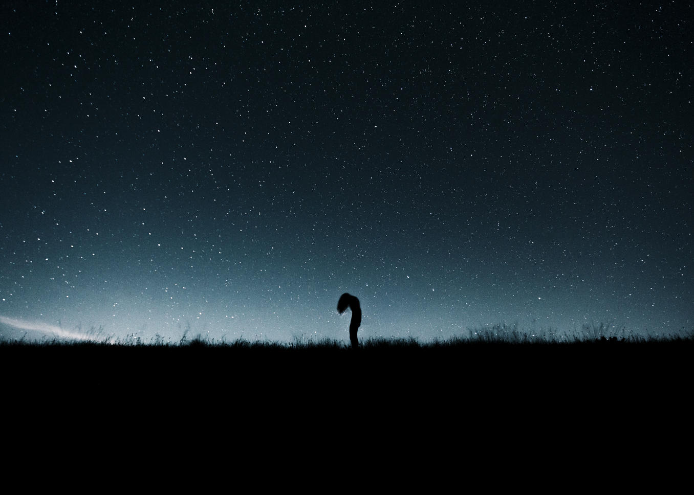 Austria, Mondsee, silhouette of woman standing under starry sky
Royalty free image