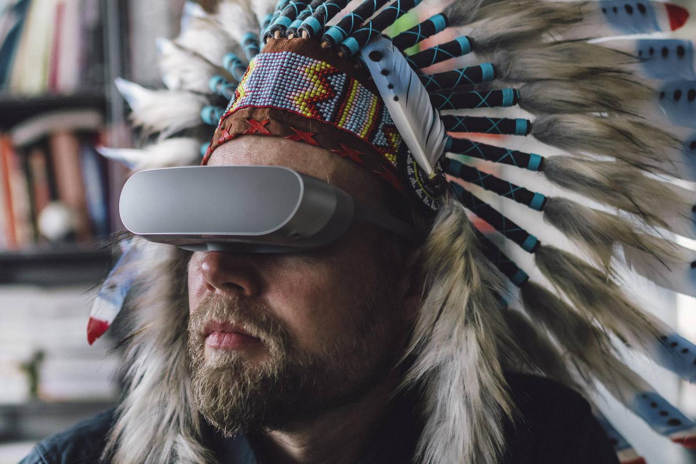 Man wearing Indian headdress and VR glasses in office
Royalty free image