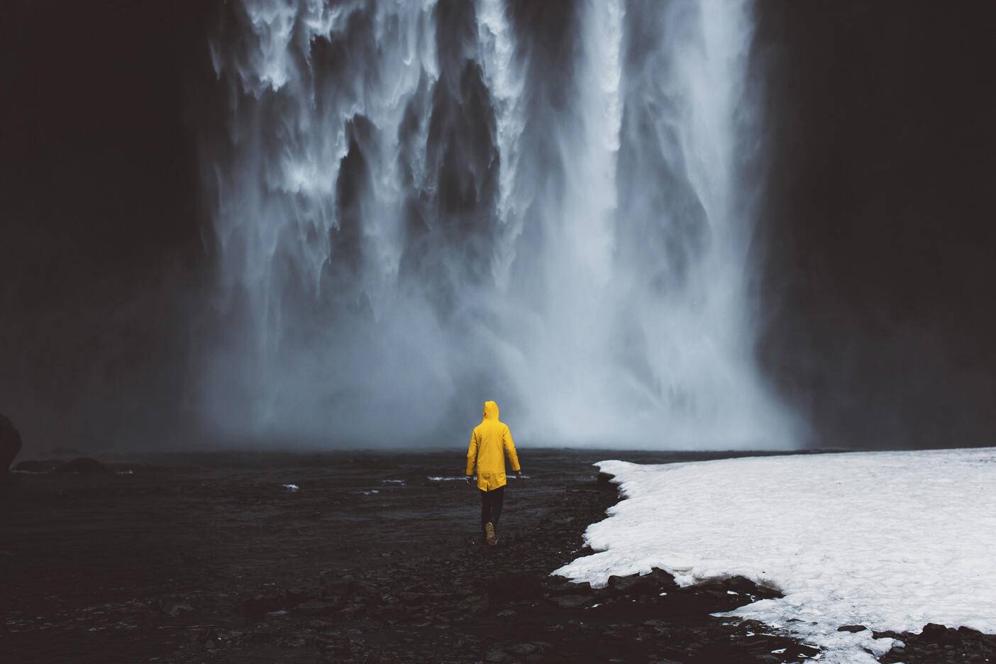 Rear view of man walking towards waterfall during winter
Royalty free image