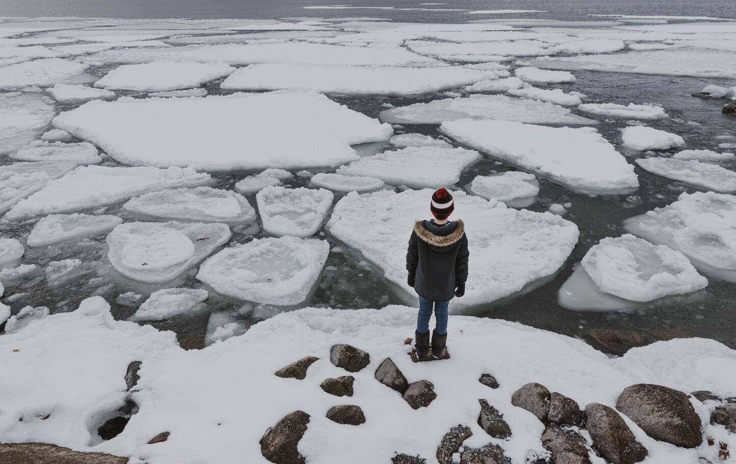Rear view of boy standing on frozen lake
Royalty free image