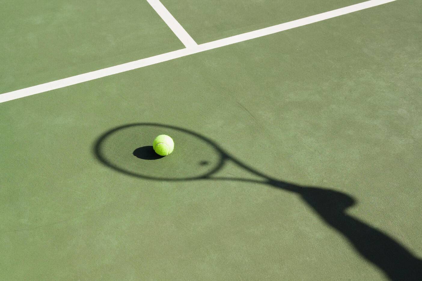 Shadow of a tennis racquet on a tennis court
Royalty free image