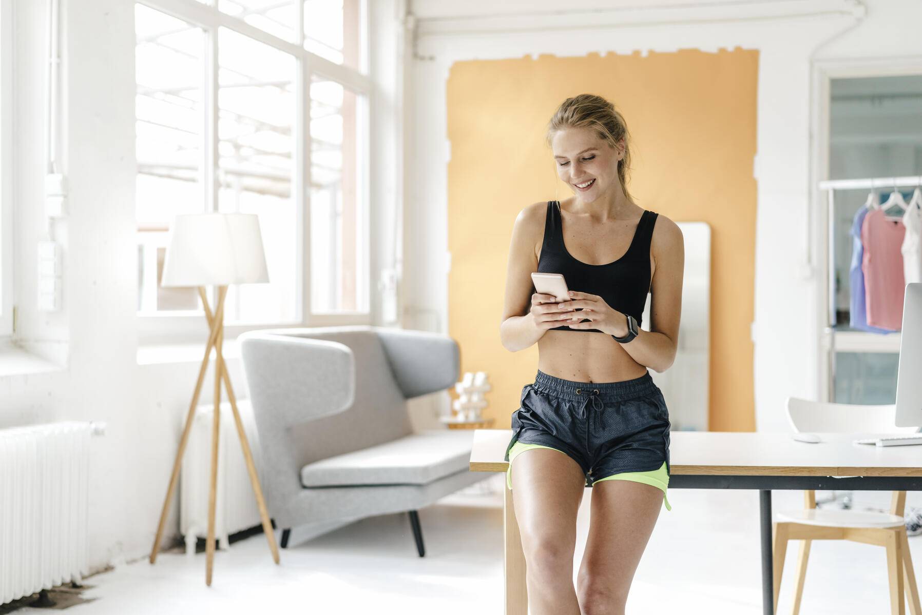 Smiling young woman in sportswear looking at cell phone
Royalty free image