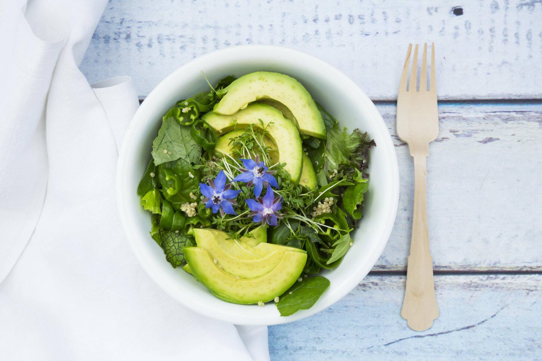 Detox Bowl of different lettuces, vegetables, cress, quinoa, avocado and starflowers
Royalty free image