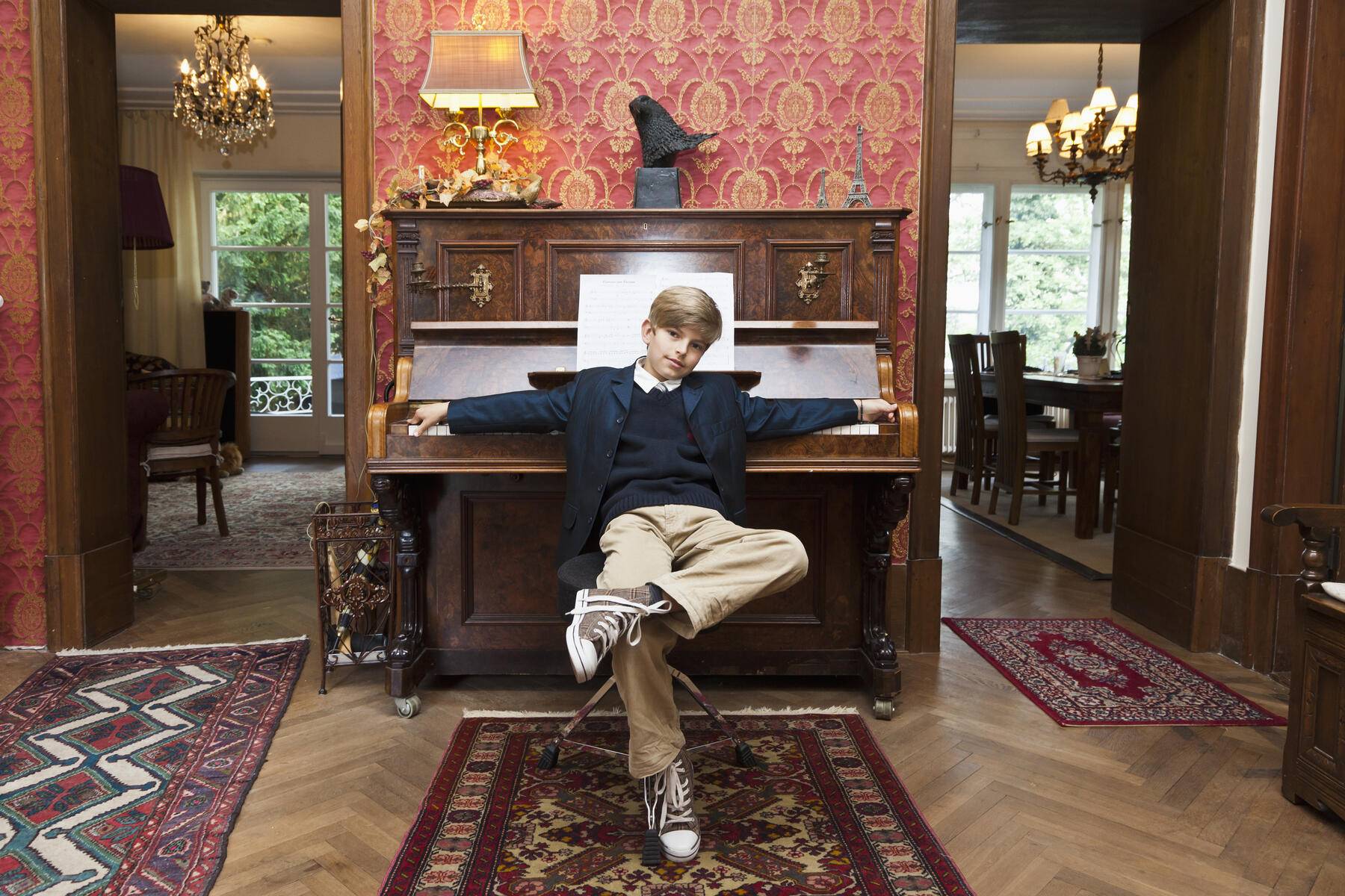 A boy with a cool attitude posing at an old-fashioned upright piano Royalty free image A boy with a cool attitude posing at an old-fashioned upright piano
Royalty free image