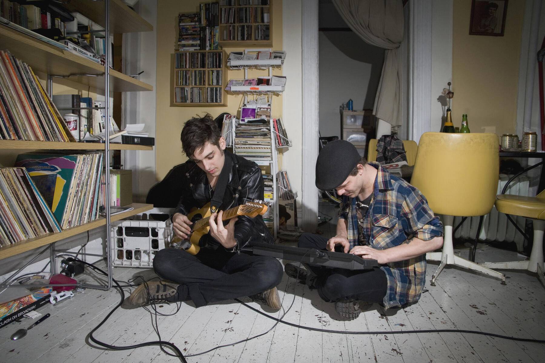 Two young men playing instruments in their living room Royalty free image Two young men playing instruments in their living room
Royalty free image