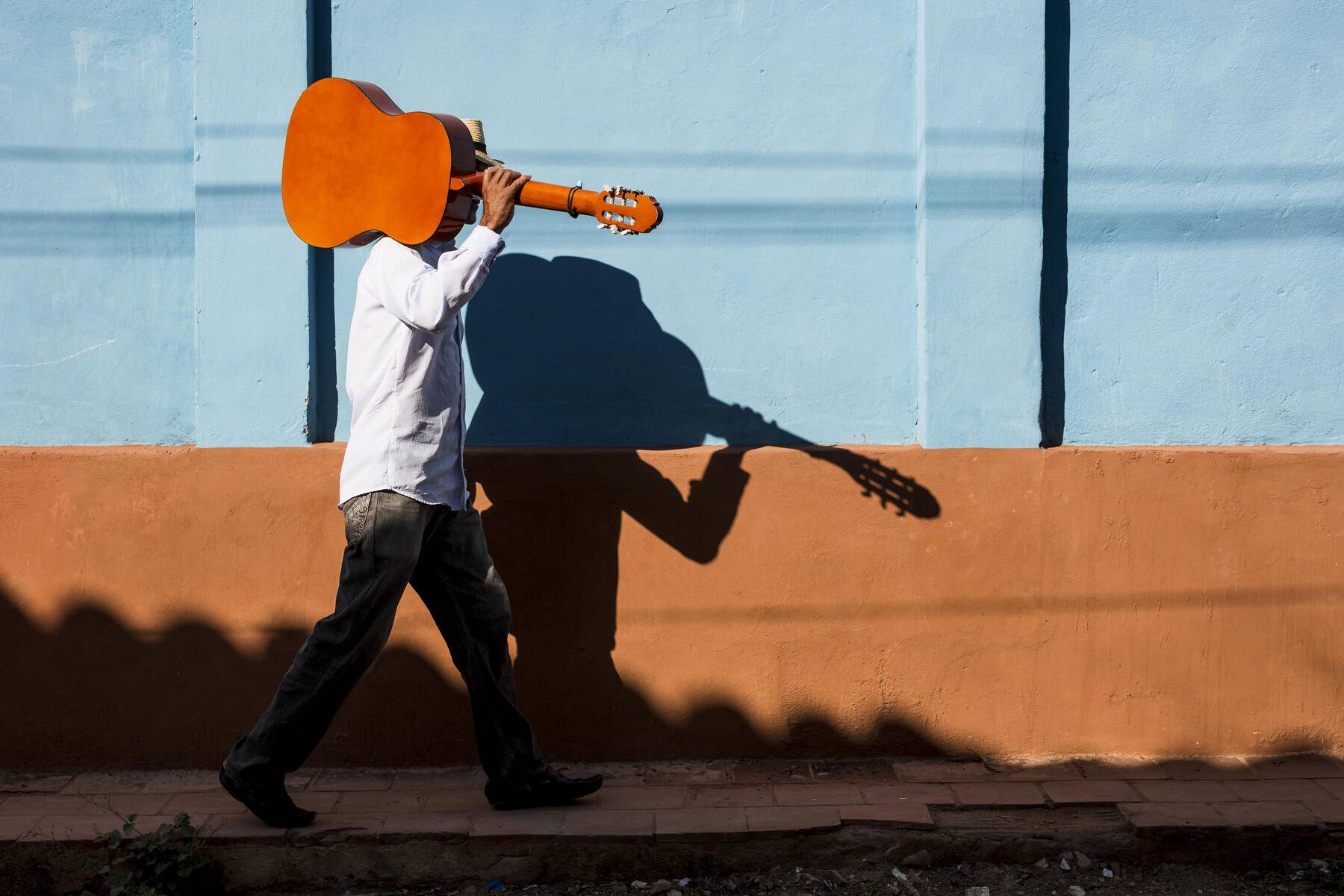 Cuba, man with guitar walking on the street Royalty free image Cuba, man with guitar walking on the street
Royalty free image