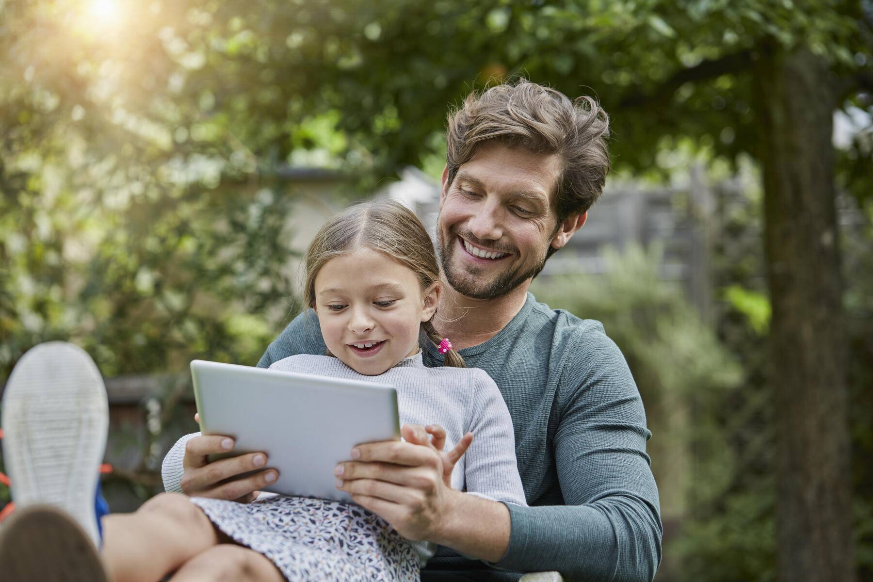 Happy father and daughter using tablet together in garden
Royalty free image