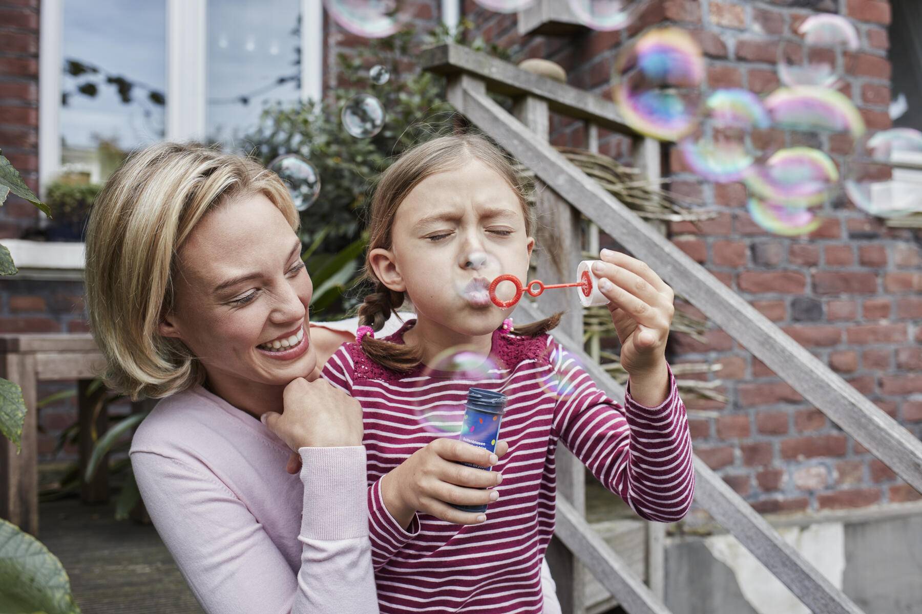 Happy mother and daughter making soap bubbles
Royalty free image