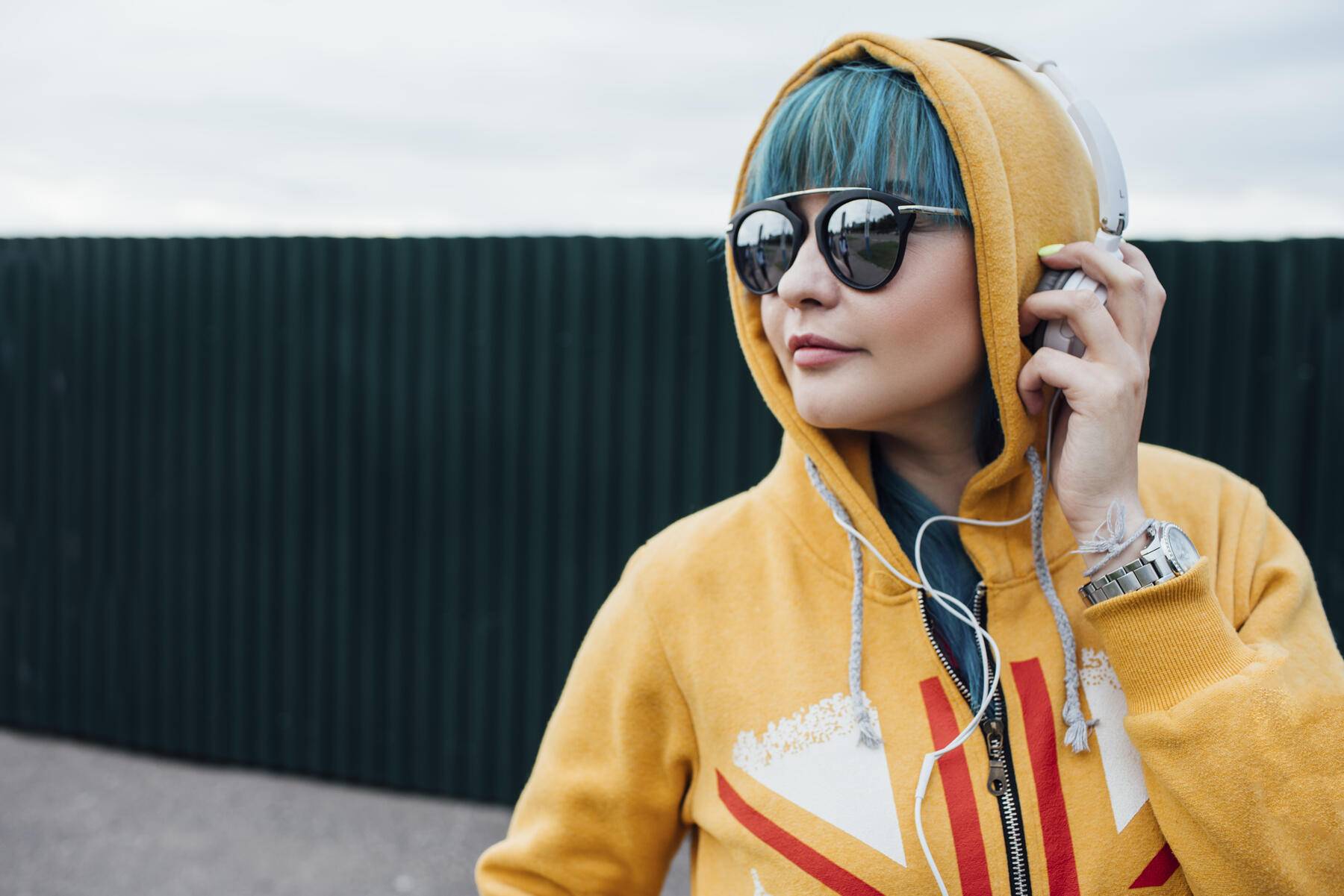 Portrait of young woman with dyed blue hair listening music with headphones Royalty free image Portrait of young woman with dyed blue hair listening music with headphones
Royalty free image