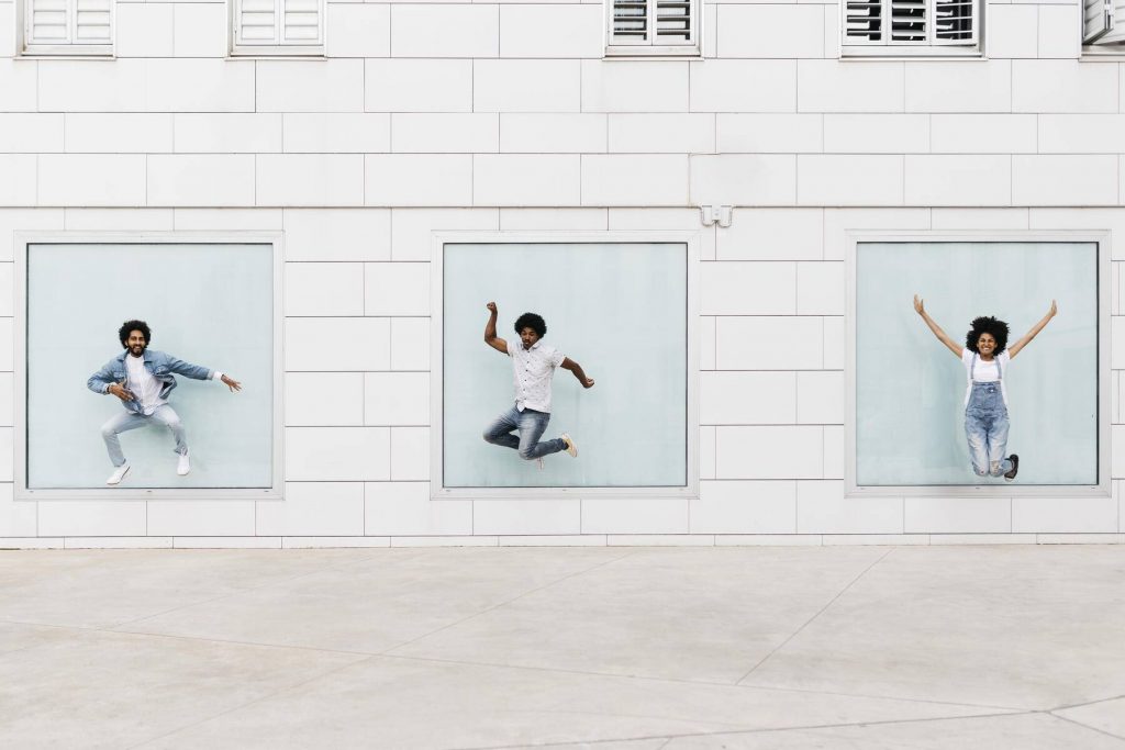 Three friends jumping together in the air - JRFF01761
