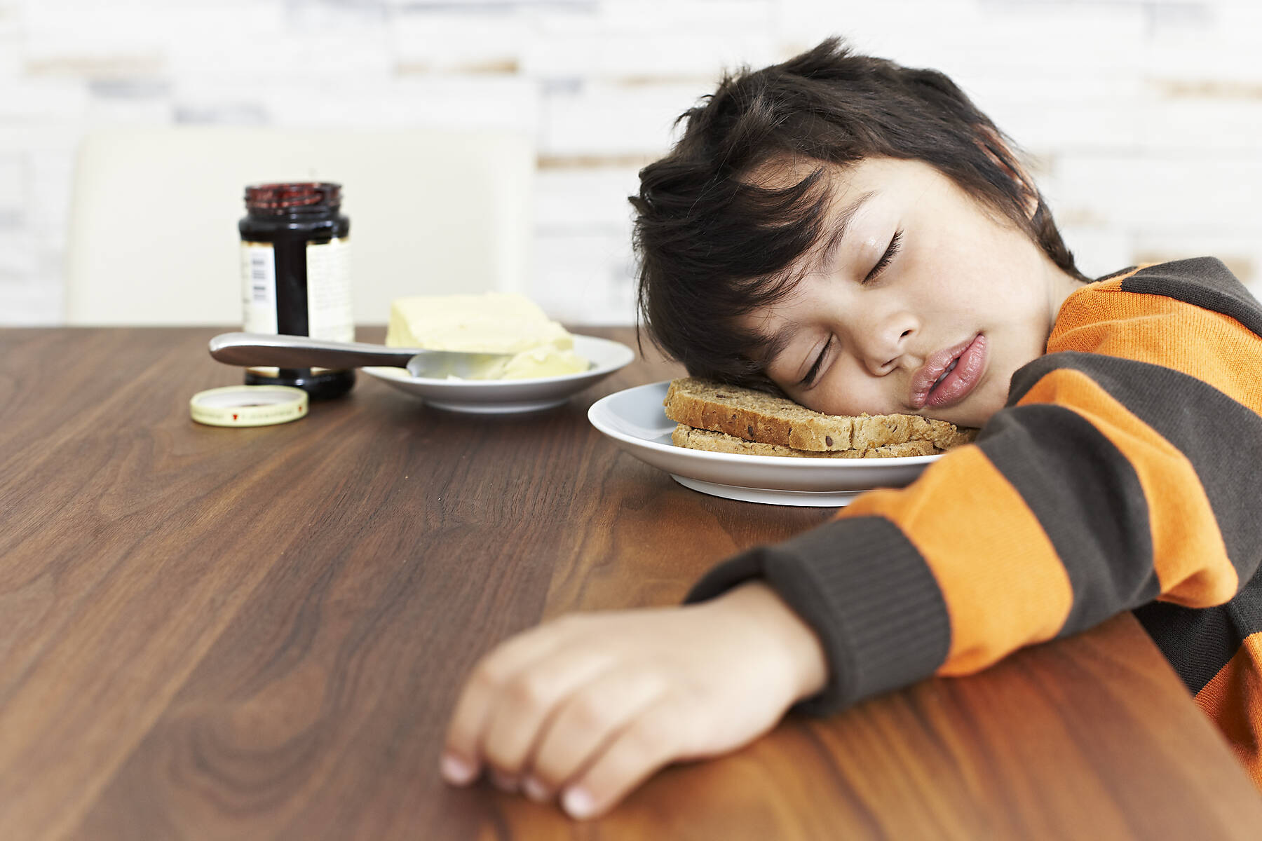 stock image, royalty-free, Portrait of little boy sleeping at breakfast table