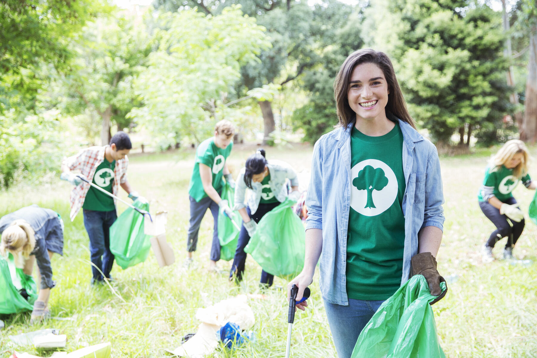 stock image, royalty-free, Portrait of smiling environmentalist volunteer picking up trash