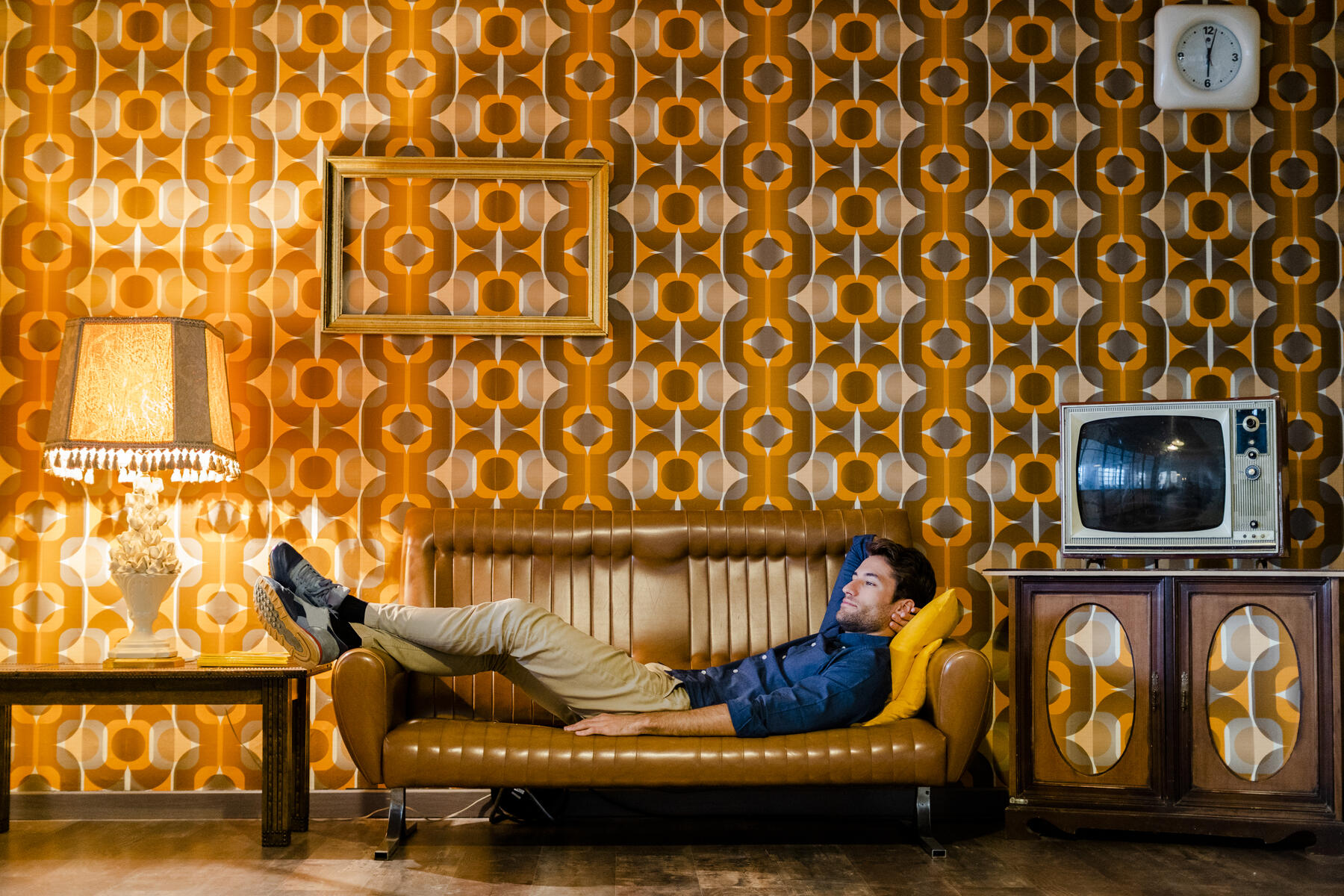 stock image, royalty-free, Man lying on couch in vintage living room