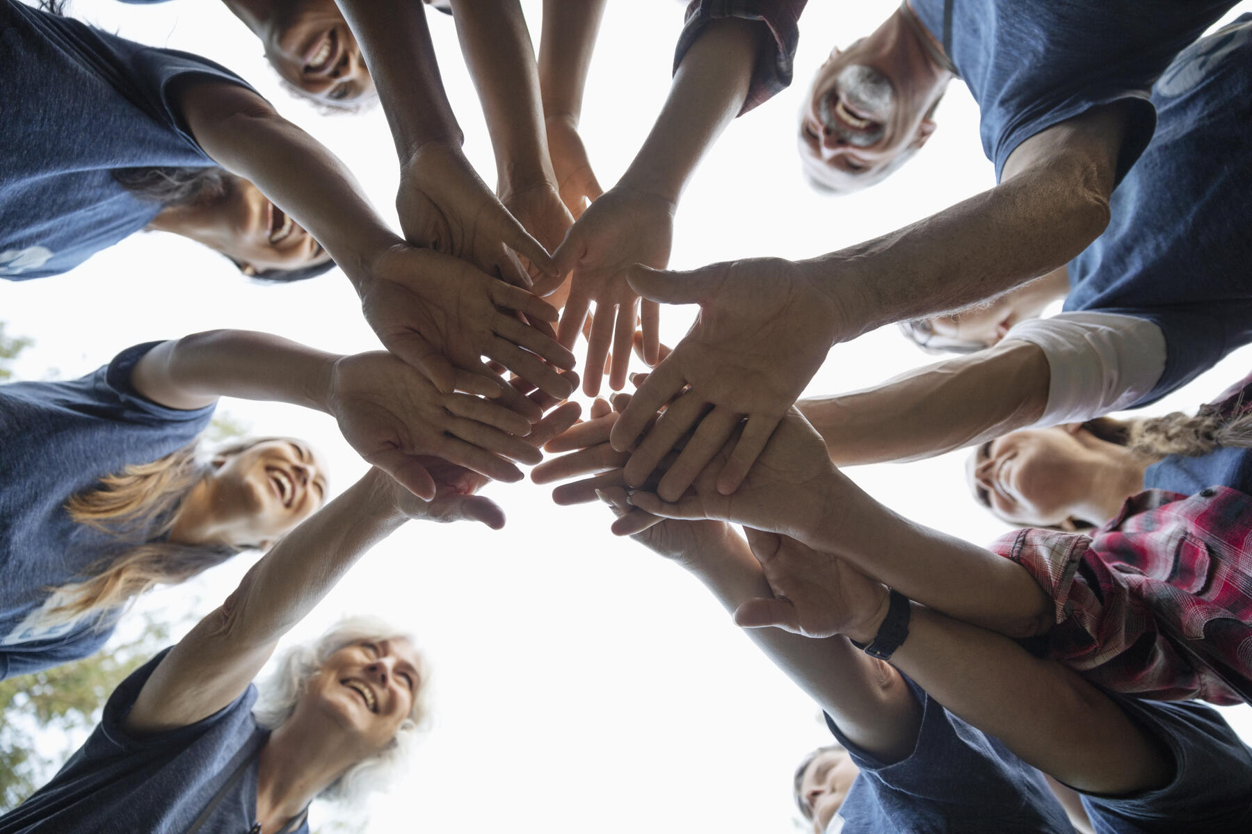 stock image, royalty-free, Happy volunteers joining hands in huddle