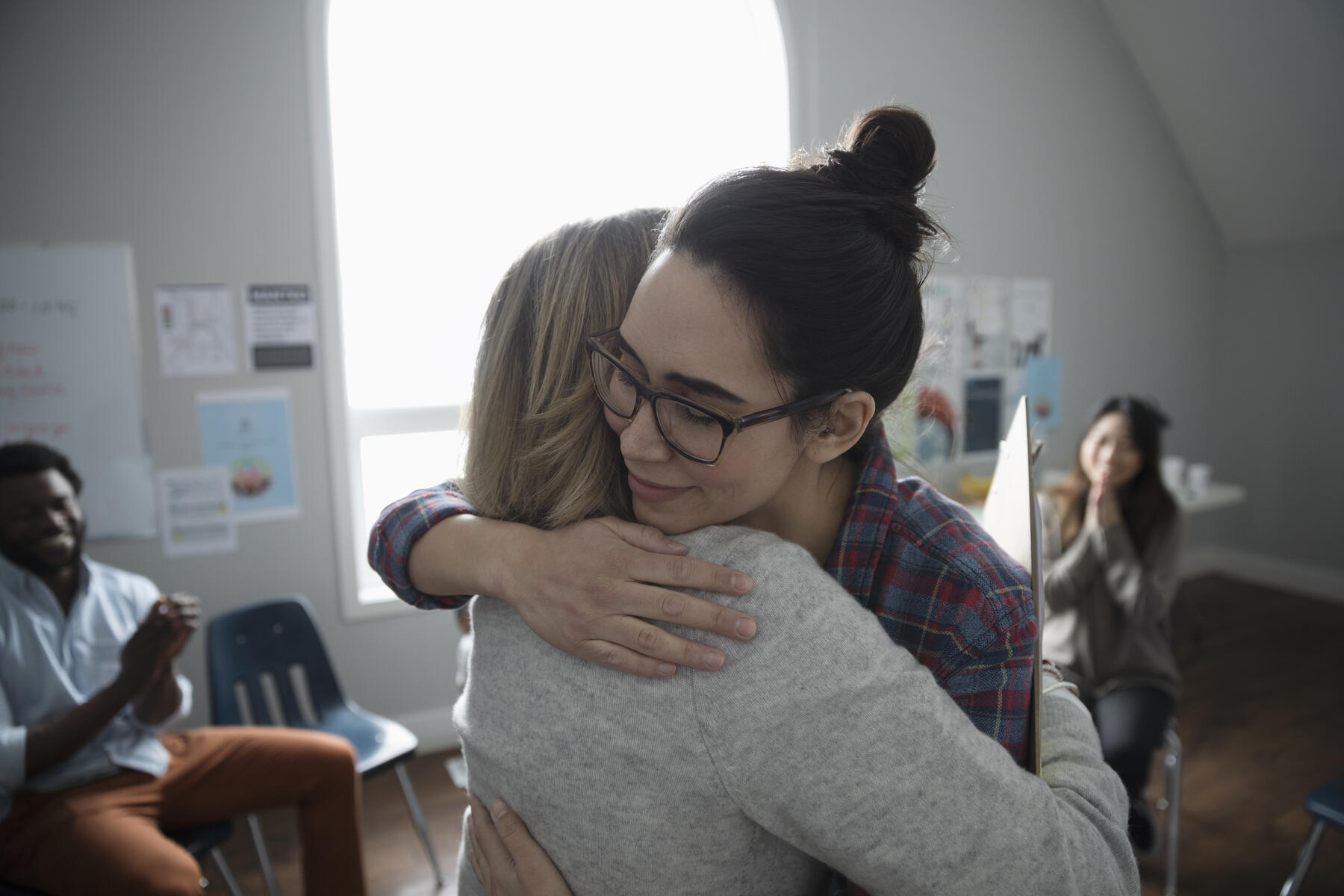 royalty-free stock image, Women hugging in support at support group in community center