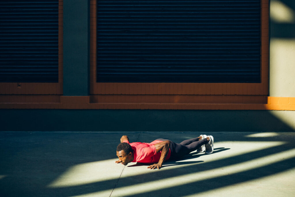 royalty-free image Young sportive man doing pushups outdoors