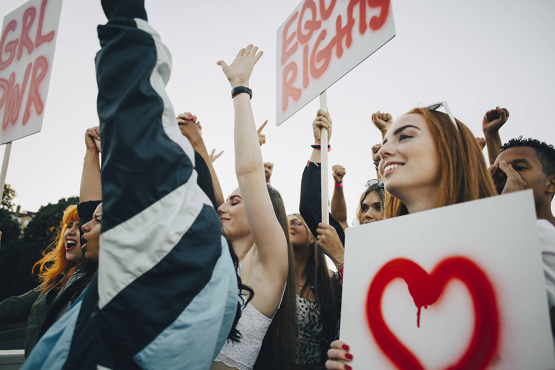 stock image, royalty-free, Low angle view of smiling women protesting with banners in city