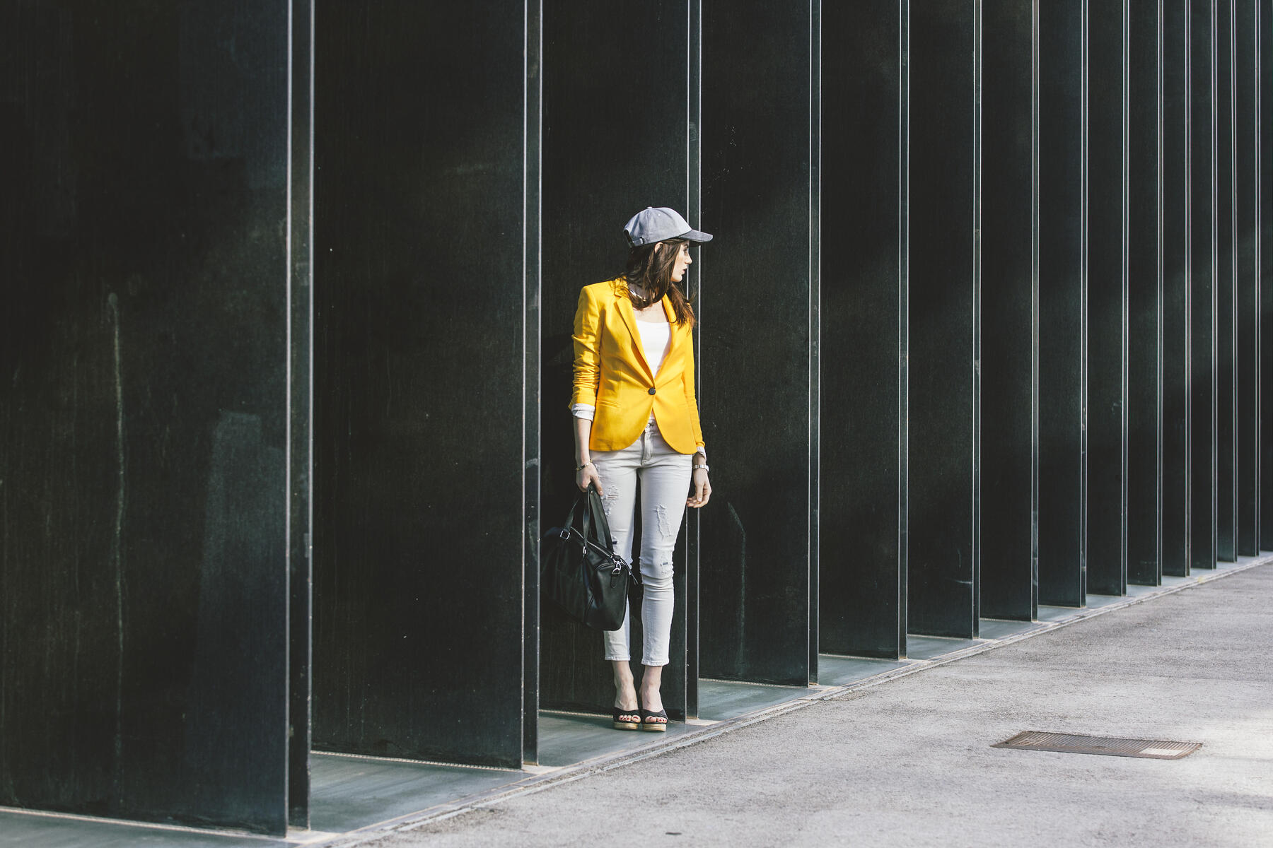 Spain,Catalunya, Barcelona, young modern woman with yellow jacket on the move, stock image, royalty-free