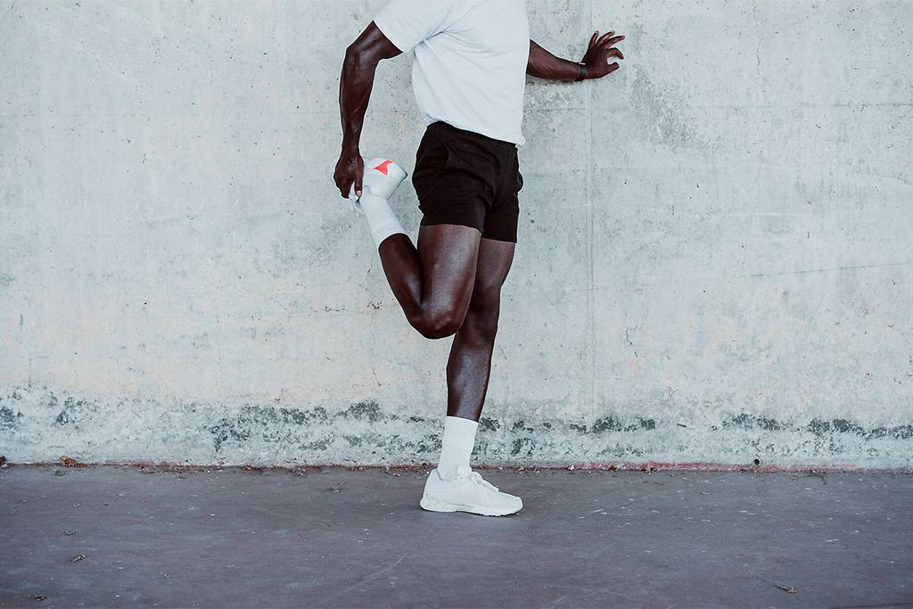 Young athlete doing stretching exercise while standing by wall
Royalty free image