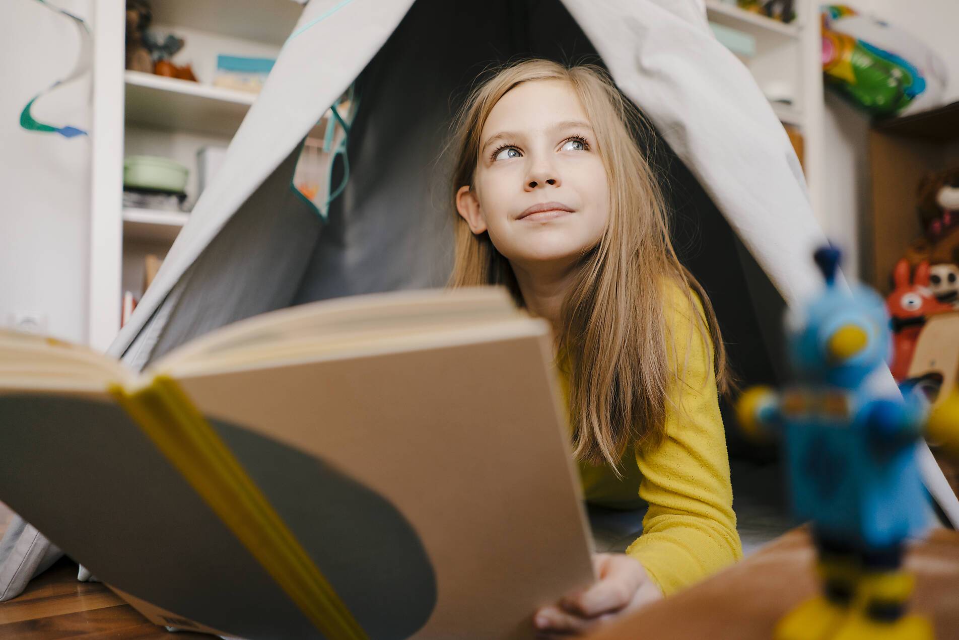 stock image, royalty-free, Girl at home reading book in children's room