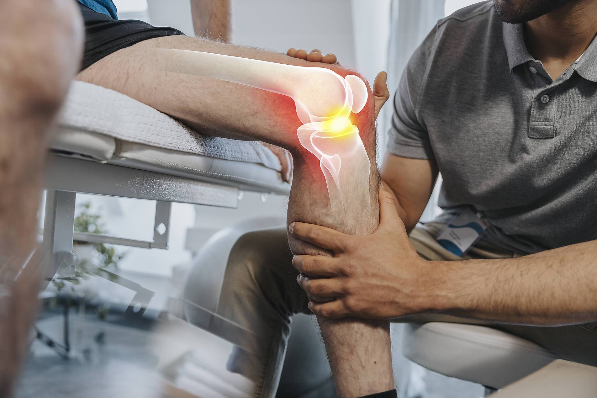stock image, royalty-free, Physical therapist checking knee joint of patient at medical examination room