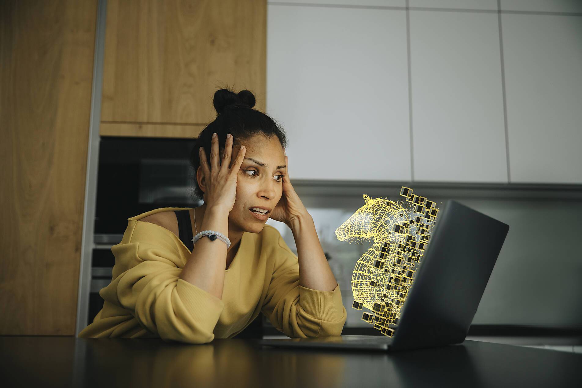 stock image, royalty-free, Woman with head in hands looking at Trojan virus icon on laptop