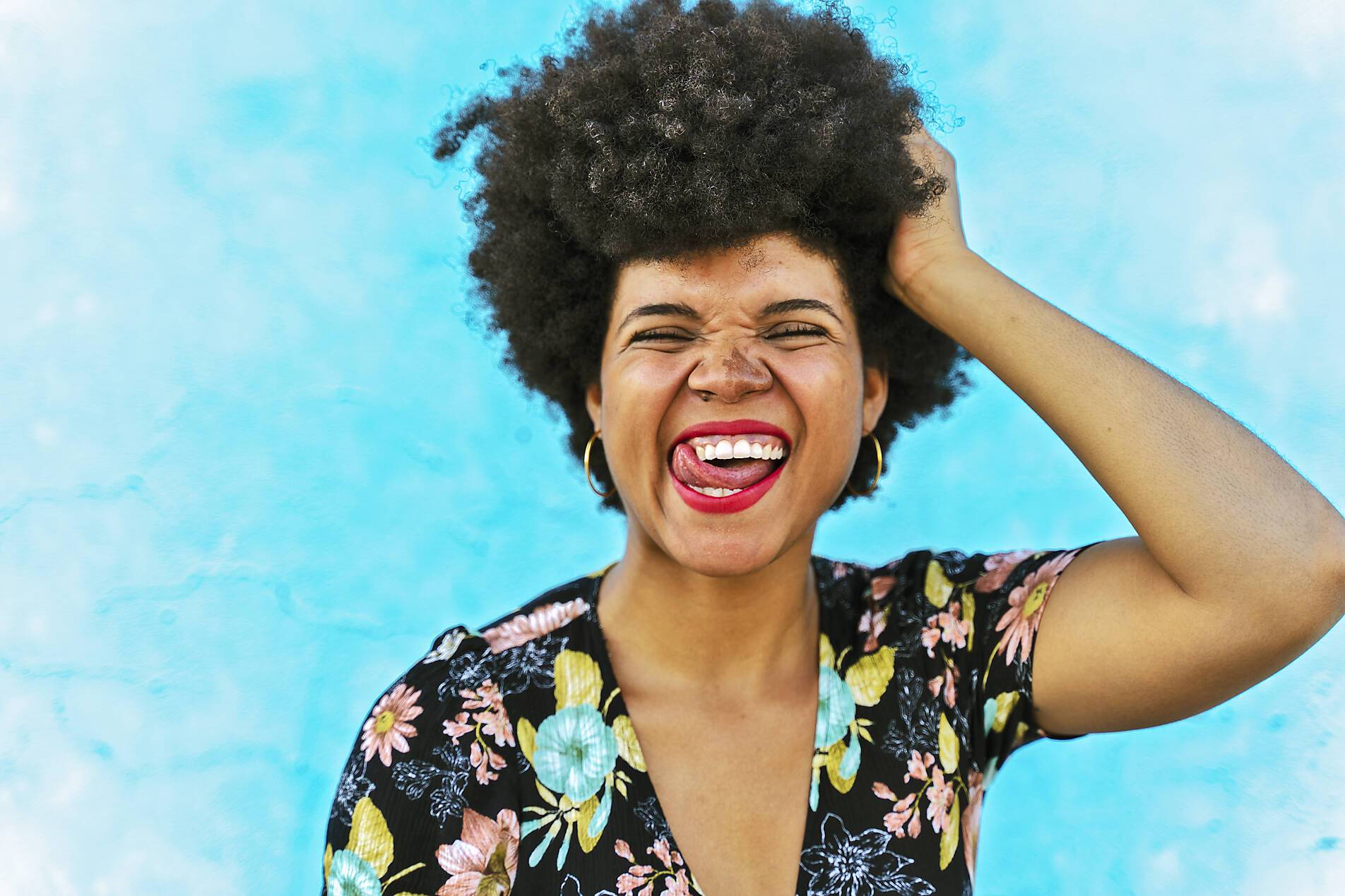 Stock image, royalty-free, Portrait of female Afro-American woman, hand in hair, joy of life
