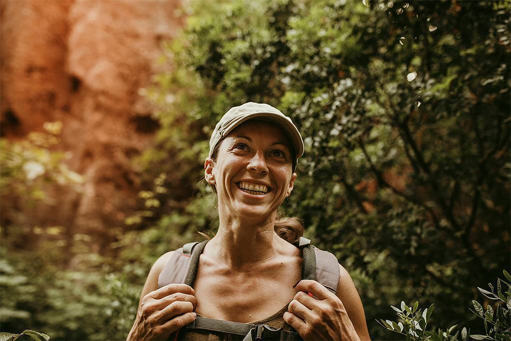 stock image, royalty-free, Smiling woman explorer standing in forest