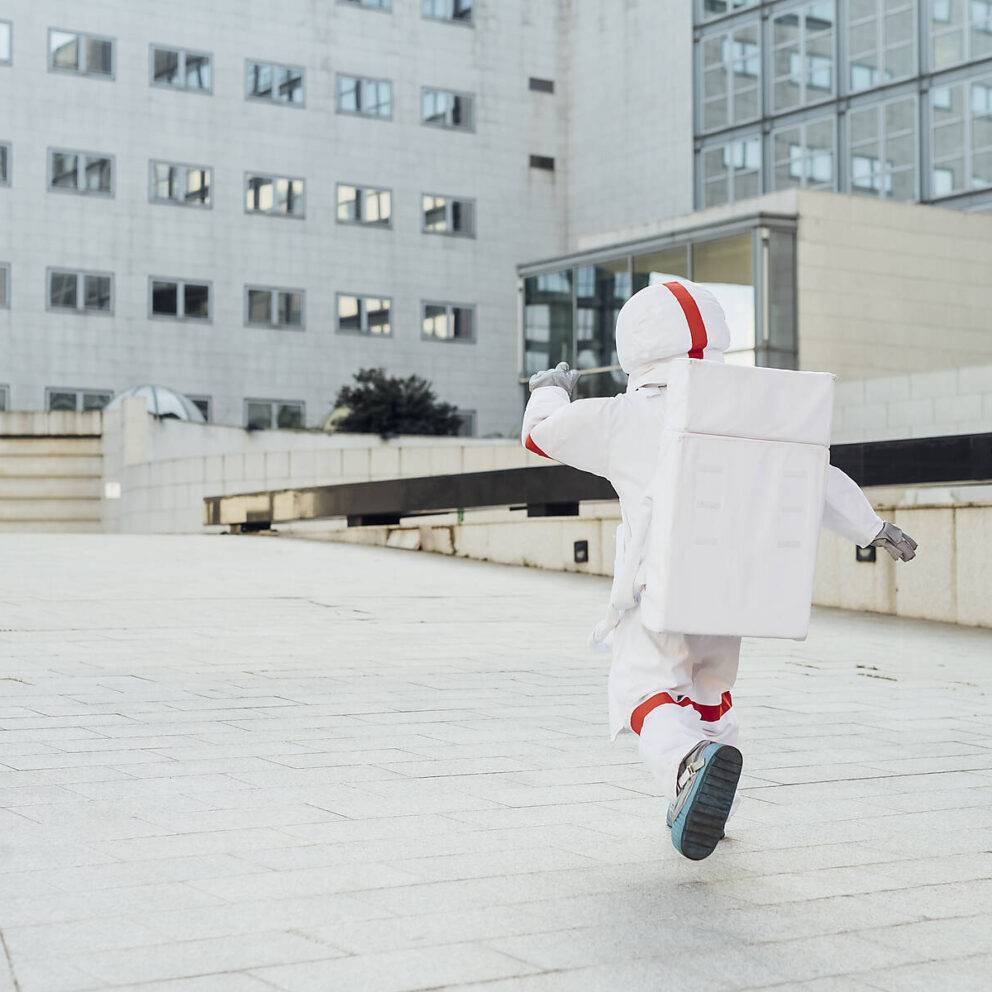 stock image, royalty-free, Woman astronaut just landed for the first time in town - Italy, Lombardy, Milan - freedom, ambition, new planets, exploration, surreal