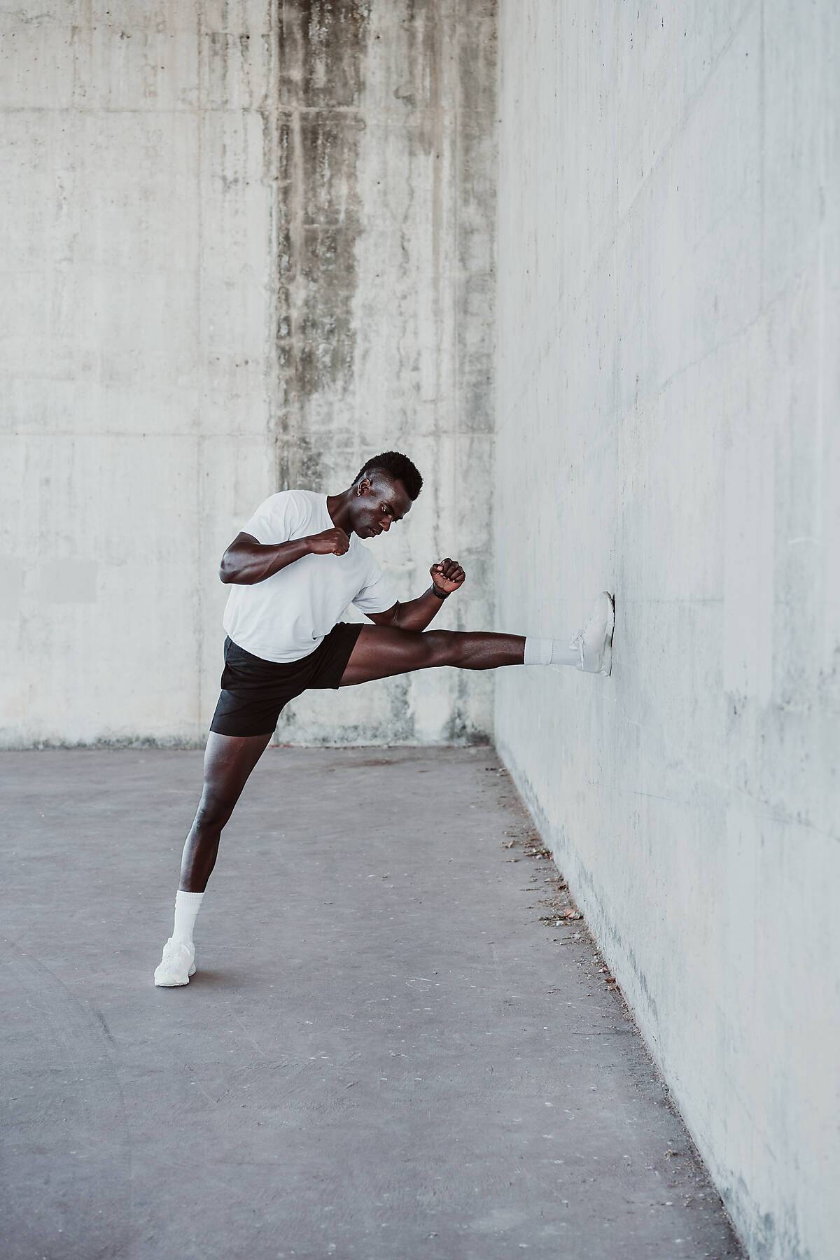 Stock Image, royalty-free, Male athlete exercising by white wall