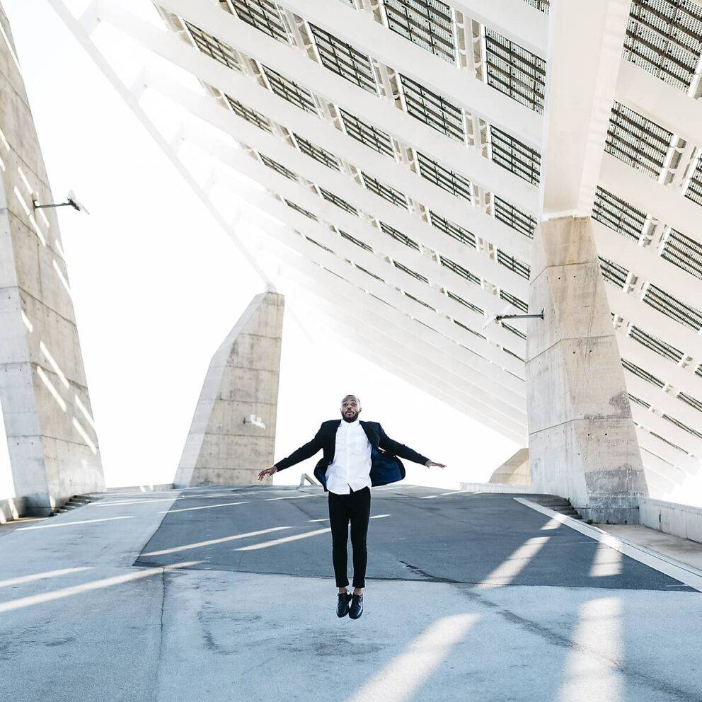 stock image, royalty-free, Vital businessman jumping under solar panels