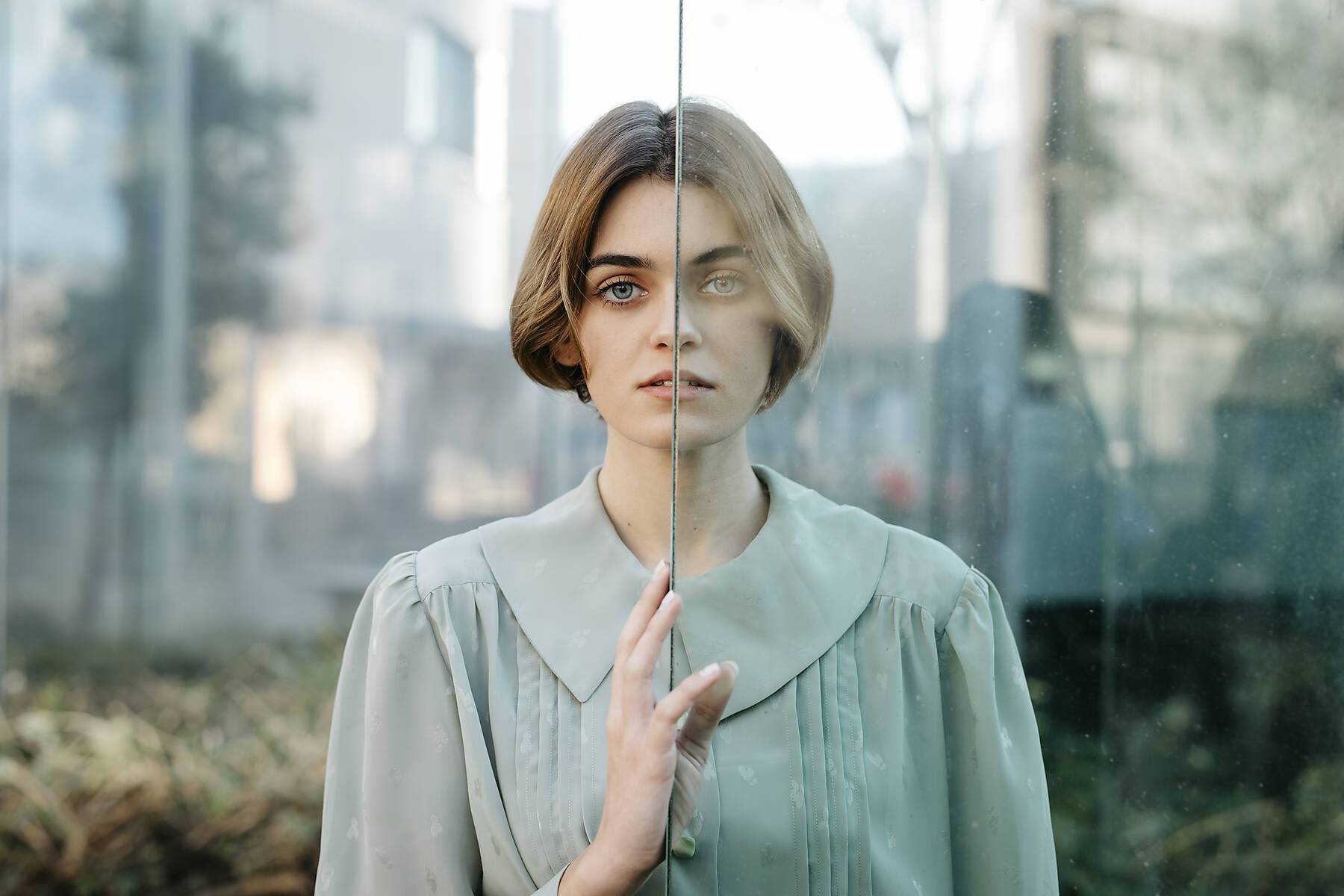 stock image, royalty-free, Portrait of woman with half of her face behind a glass