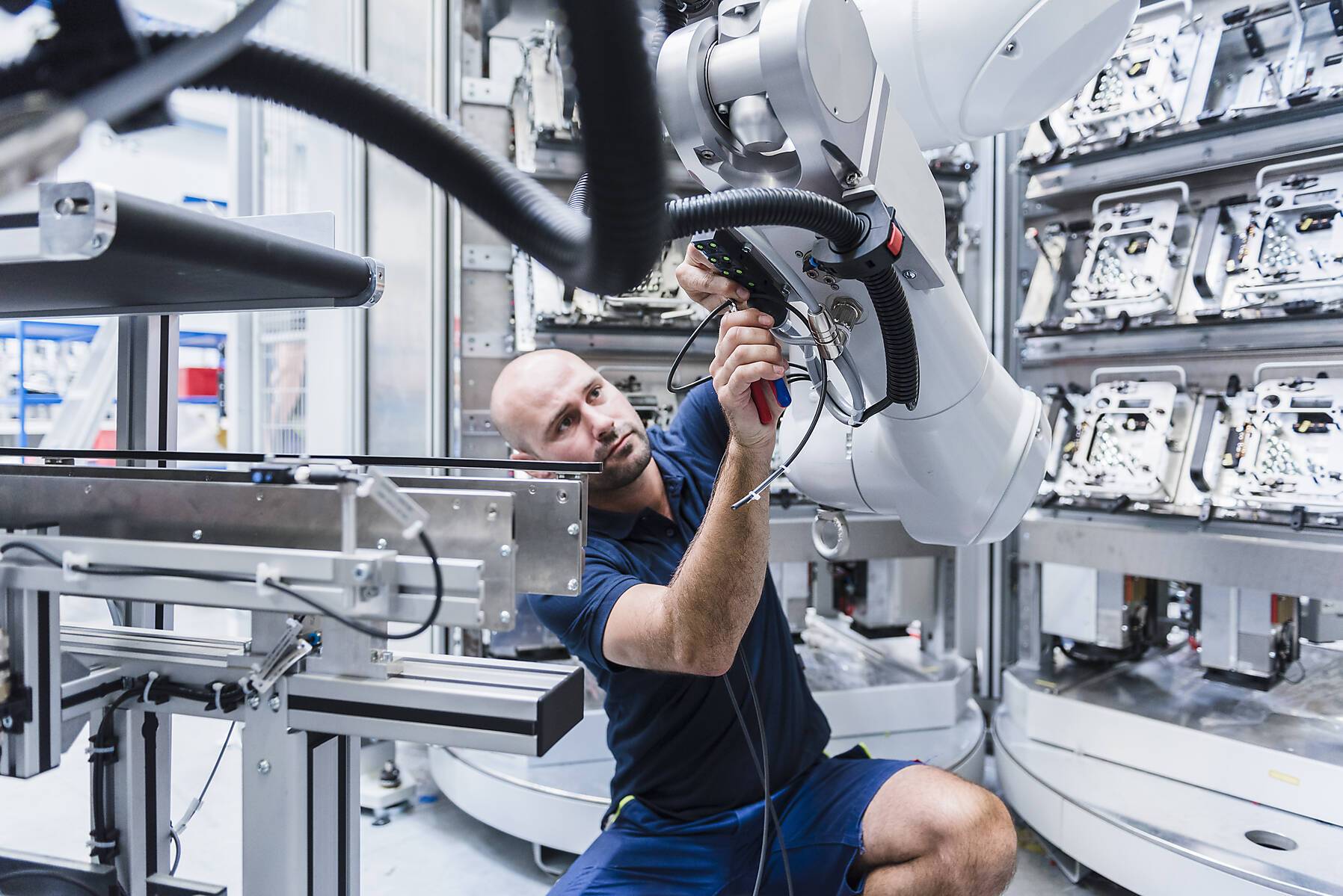 stock image, royalty-free, Man working at industrial robot in modern factory